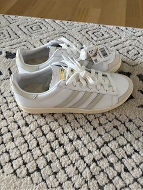 adidas White Sneakers with Light Gray Stripes and Gold Accents